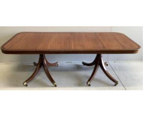 A reproduction mahogany twin pillar extending dining table, extended 300cm, two spare leaves, depth 91cm, height 72cm. Condit