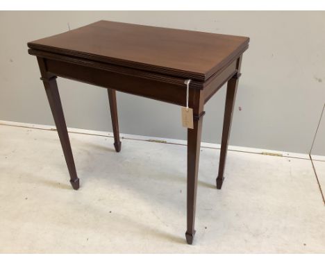 An Edwardian mahogany rectangular folding card table, width 70cm, depth 42cm, height 74cm. Condition - fair