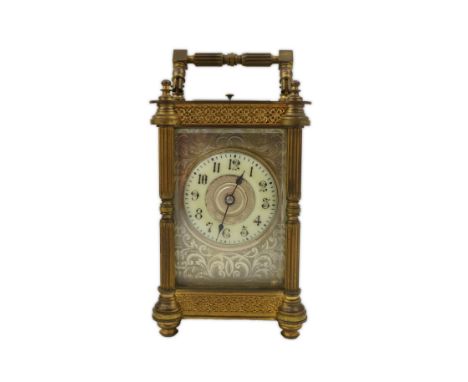 A late 19th century French brass repeating carriage clock, the dial with engraved and silvered mask, unsigned, portable in or