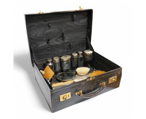 A George V leather travelling toilet case, containing nine silver mounted accoutrements, Mappin &amp; Webb, London, 1917 and 
