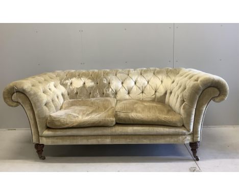 A Beaumont &amp; Fletcher Grenville two seater chesterfield settee in buttoned lemon velvet on turned feet with brass castors