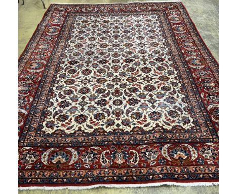 A North West Persian ivory ground floral carpet, 350 x 254cm. Condition - fair, one area of worn pile