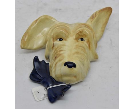 Beswick Sealyham wall plaque; number 373, bow on left, cream dog with dark blue bow