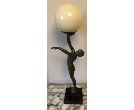 Art Deco figural table lamp of semi naked female with white glass ball shade. 63cms h. Appears to be spelter.&nbsp;Condition 