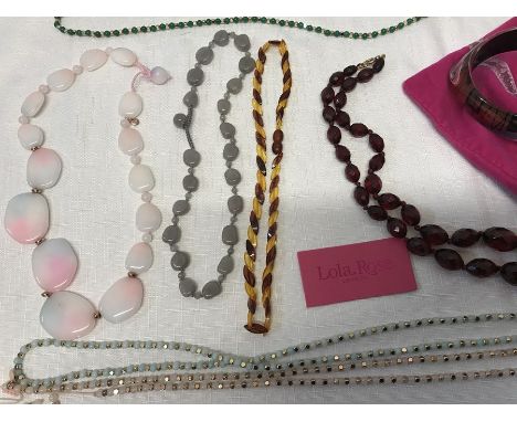 Costume jewellery by Lola Rose of London beaded necklaces and a bangle with velvet bags. 