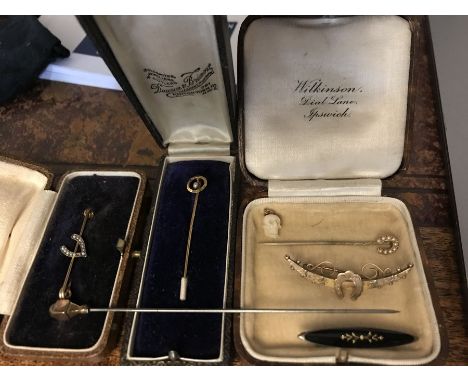 A nine carat gold bar brooch, horse shoe stick pin set with seed pearls, seed pearl pin in original box, hat pin top marked 9