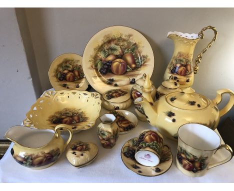 A large quantity of Aynsley Orchard Gold ceramics including teapot, jugs, mug, plates and dishes.Very good condition.