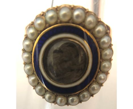 A 19thC mourning ring, hair locket to centre with blue and white enamel surrounded by natural pearl edges in yellow gold. 6.1