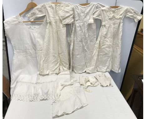 A collection of vintage cotton and lace to include three christening gowns 68cm and bonnet with intricate lace detailing toge