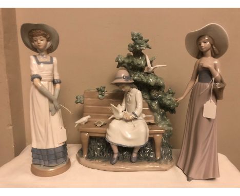 Three Nao figures, a girl on a bench feeding birds, 34cms and two young girls. 