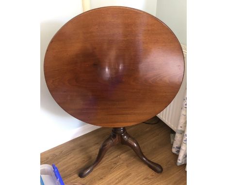 A mahogany 19thC tip top tripod table on gun barrel stalk and tripod base. 76cms d. 