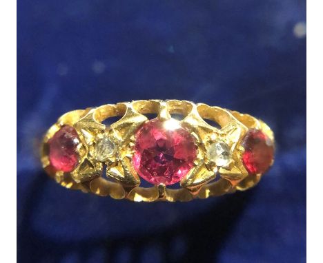 An 18ct gold diamond and ruby set ring, size N/O, 2.4gms. 