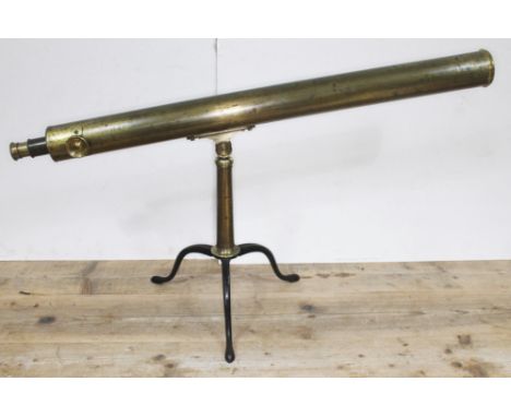 A late 19th century 3" astronomical brass telescope on tripod base.  