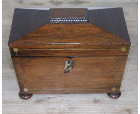 A Regency rosewood tea caddy of sarcophagus form, length 22cm.  