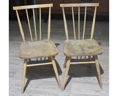 A pair of Ercol light elm and beech spindle back chairs.  