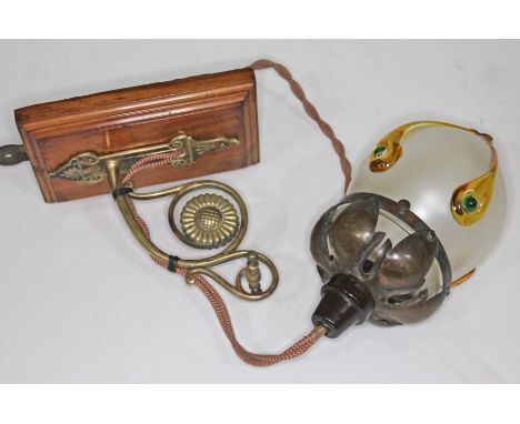 An Arts &amp; Crafts wall light with copper mounted hanging glass shade, brass and wood bracket.  