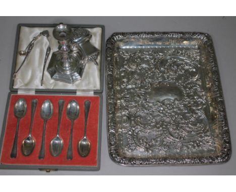 A mixed lot of hallmarked silver comprising an embossed tray, a cased set of teaspoons, a candlestick, a pepper pot and a spo