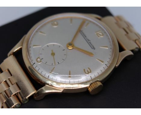 A vintage 1950s Jaeger LeCoultre 9ct gold wristwatch, with signed silver dial, gold hour indices with 3-6-9-12 Arabic numeral