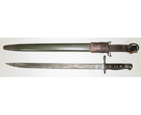 A WWI 1913 Remington US bayonet with scabbard and leather sheath with lock mechanism, length 59cm.  