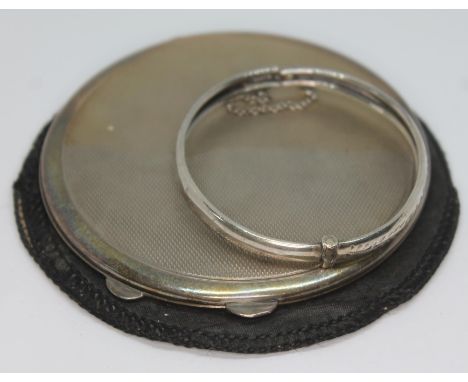 A hallmarked silver compact and a child's silver bangle.  