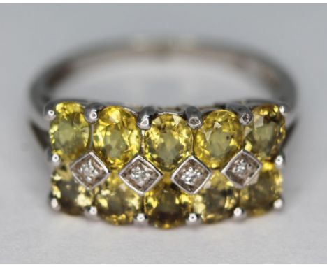 A 9ct white gold ring set with yellow and colourless stones, marked '9k', gross wt. 2.83g, size L.  