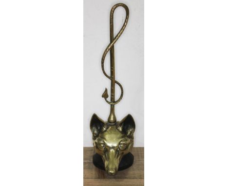 A hunting themed door brass and cast metal door stop formed as a fox's head with riding crop, height 46cm.  