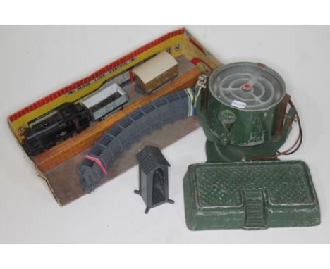 An Astra search light, a lead sentry box and a 1950s clockwork train set.  