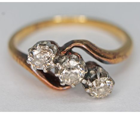 An 18ct gold three stone diamond ring, marked '18ct', gross wt. 3.66g, size N.  