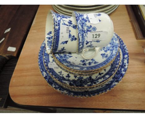 A part tea service with blue leaf and gilt decoration