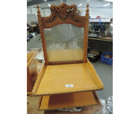 A folding wall mirror and shelf