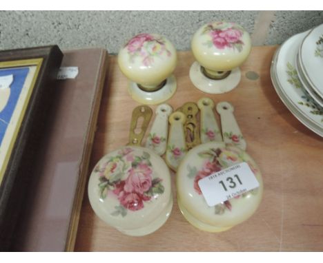 Four ceramic door knobs and keyhole covers with pink and cream rose design