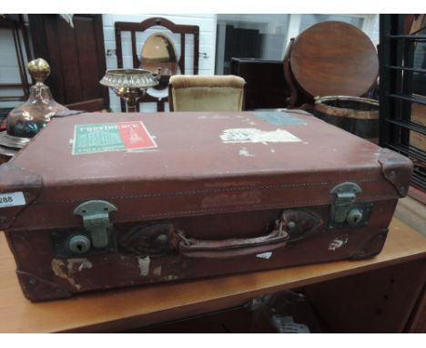 A vintage leather suitcase bearing Belgium labels etc