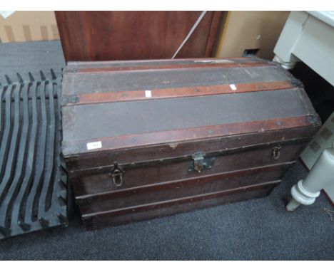 An early 20th century wood bound dome top cabin trunk
