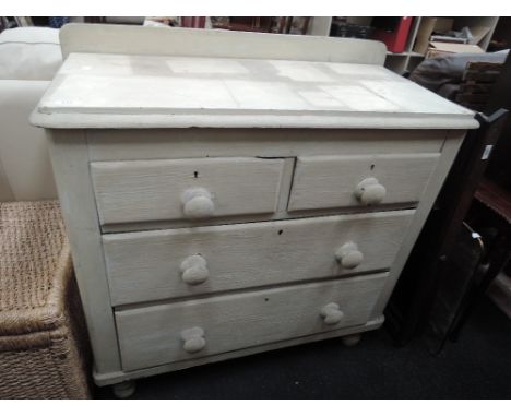 A vintage painted pine chest of 2 short and 2 long drawers