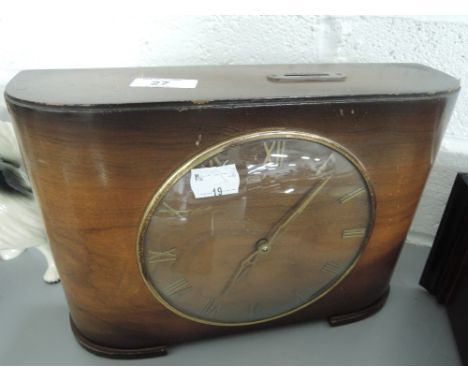 A vintage mantle clock with coin slot marked 'Two florins weekly'