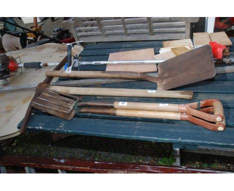 Small garden fork, spade, pick axe and shovel.
