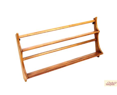 A light Ercol plate rack 