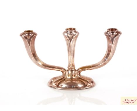 A continental white metal three light candelabra 