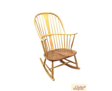 An Ercol light elm stick back rocking chair 