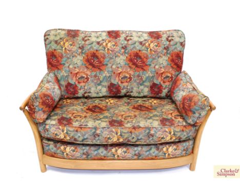 An Ercol "Renaissence" two seater settee with floral upholstered loose cushions 