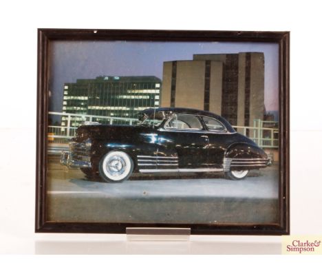 A photographic print of a 1957 Chevrolet and another similar