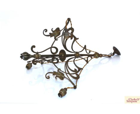 An Art Nouveau brass three branch light fitting having frosted and opaque frilled glass shades 