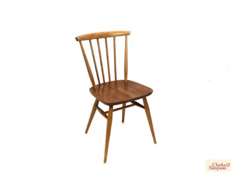 A set of four light Ercol stick back kitchen chairs 