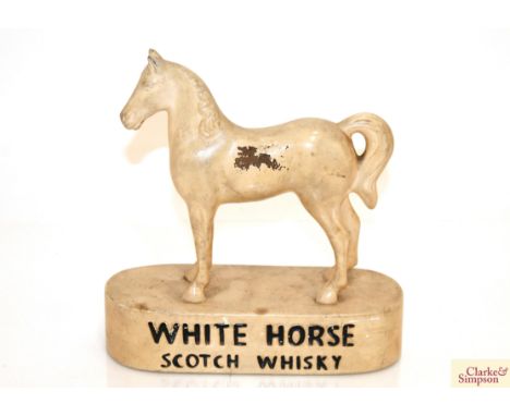 A White Horse scotch whisky advertising figure, 22cm long x 23cm high 