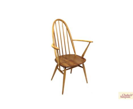 A set of four light elm Ercol stick back dining chairs, two standards and two elbows 