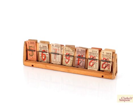 A wooden ticket stand and collection of old bus tickets 