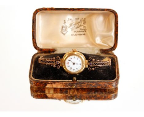 An 18ct gold ladies wrist watch having white enamel dial, the yellow metal bracelet strap inset with amethyst and seed pearl 