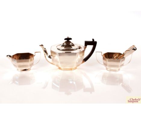 A three piece silver tea set with engine turned banded decoration, the tea pot with black wood handle and lift, Birmingham 19