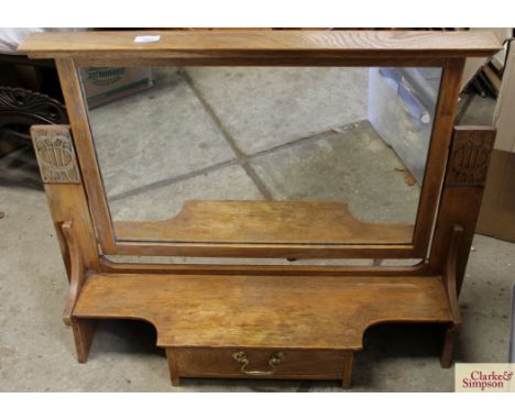 A light oak Art Deco mirror stand, having swing plate above a shaped plinth fitted with single drawer, 83cm wide x 66cm high