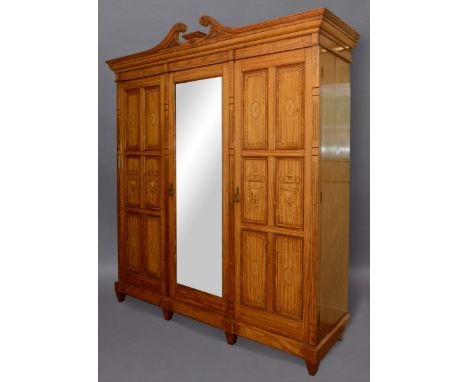 VICTORIAN SATINWOOD AND INLAID WARDROBE, the broken swan neck pediment above a mirrored and and panelled door enclosing hangi